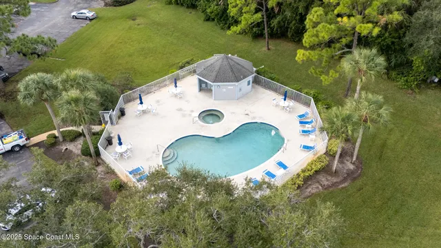 a front view of a house with garden and trees