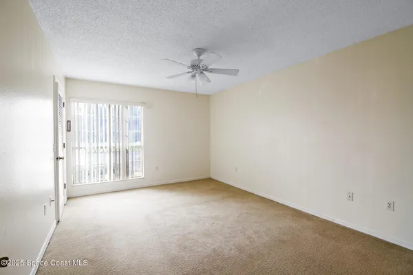 a view of room with window and ceiling fan
