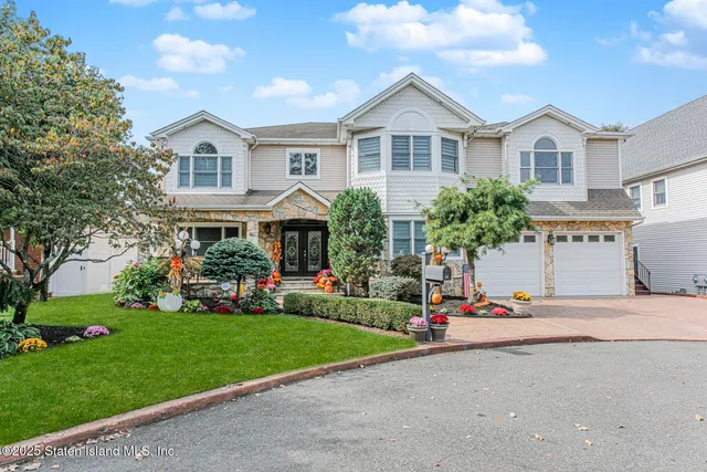 a view of a house with a patio and a yard