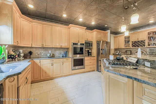 a bathroom with a granite countertop sink a toilet and a mirror