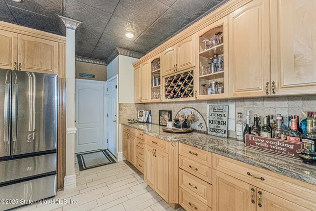 a bathroom with a granite countertop shower two mirror and a sink