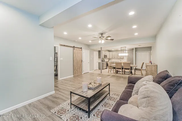 a view of a backyard with plants and outdoor seating