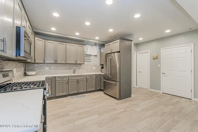 a view of a patio with a table and chairs under an umbrella