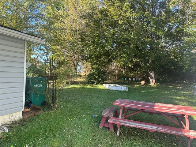 a view of backyard with trampoline