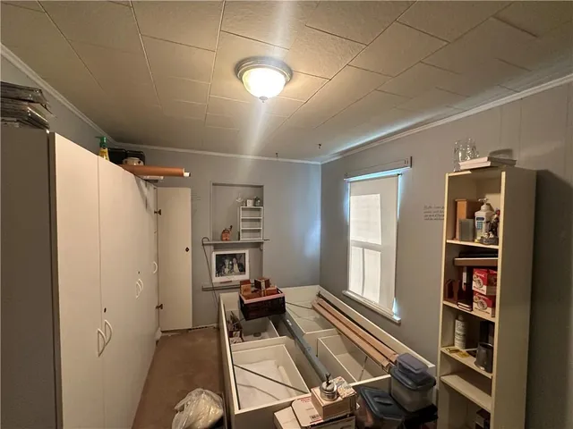 a view of a livingroom with furniture and a window