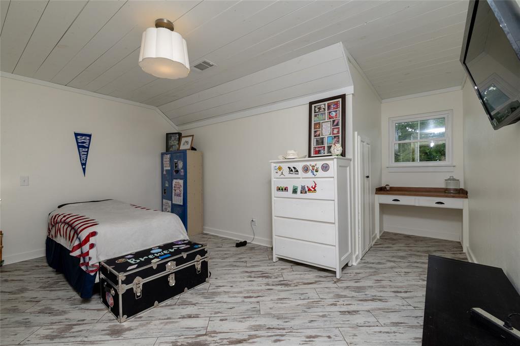 8948 David Fort Road Argyle, TX 76226 - Photo 29 of 39 Room featuring white planked ceiling, wood-finish flooring, built-in window desk, window, and a wall-mounted light fixture