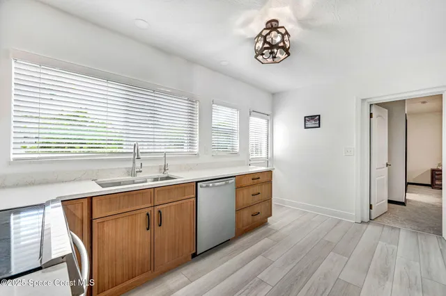a spacious bathroom with a granite countertop sink a mirror and a bathtub with shower