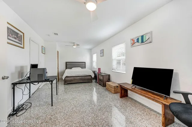 a bedroom with furniture and a flat screen tv