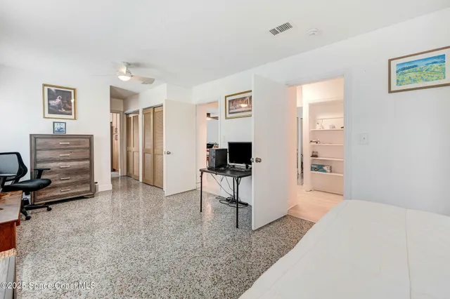a living room with furniture and a dresser