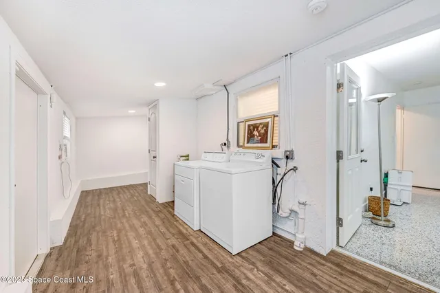 a view of a hallway with washer and dryer
