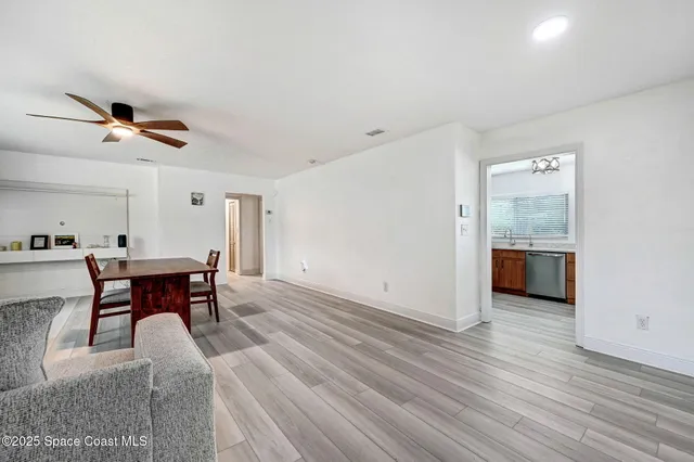a view of a livingroom with furniture and a kitchen