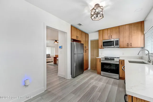 a kitchen with granite countertop stainless steel appliances and wooden cabinets