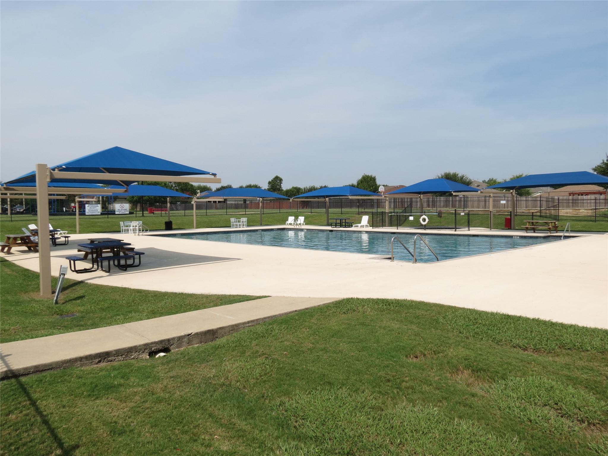375 Musgrav Kyle, TX 78640 - Photo 27 of 31 Community pool with shaded seating areas
