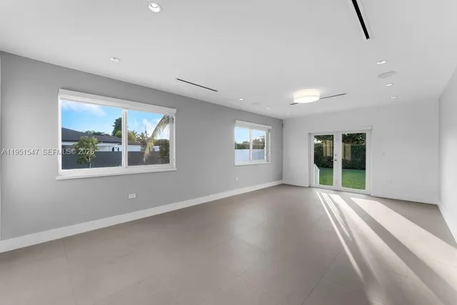 a view of a kitchen with a sink and a refrigerator