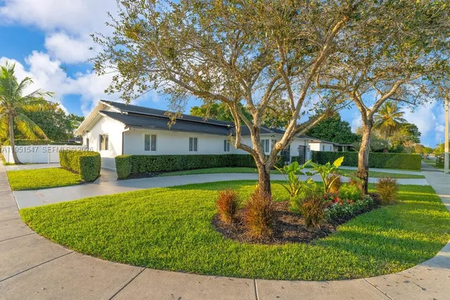 a front view of a house with garden