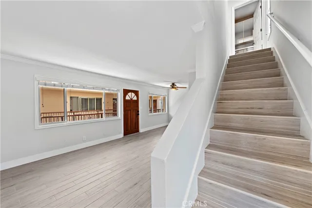 a view of an empty room and wooden floor