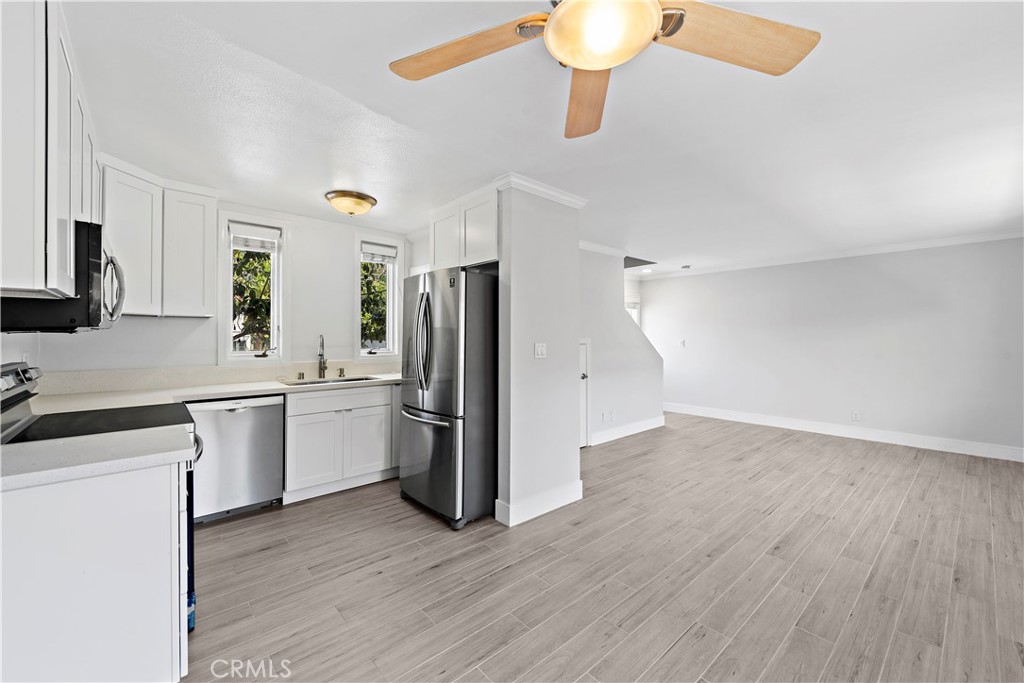 2037 South Coast Highway, Unit 11 Laguna Beach, CA 92651 - Photo 4 of 32 a kitchen with a refrigerator and a sink