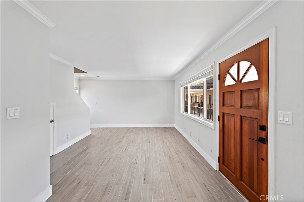 2037 South Coast Highway, Unit 11 Laguna Beach, CA 92651 - Photo 10 of 32 wooden floor in an empty room with a window