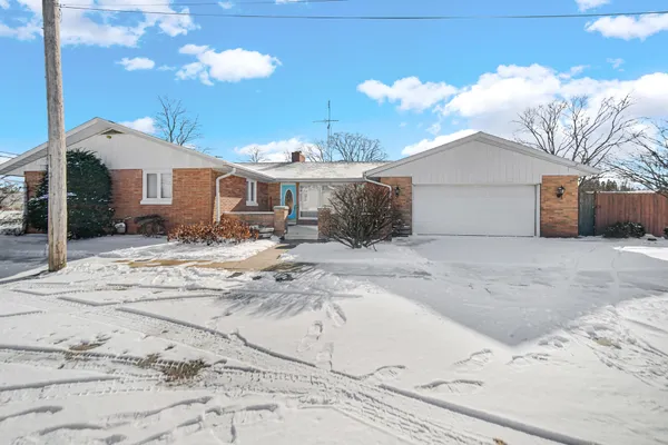 a view of a house with a snow in the yard