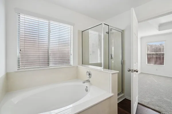 a bathroom with a bathtub and a shower