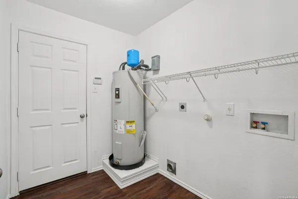a view of storage and utility room with wooden floor