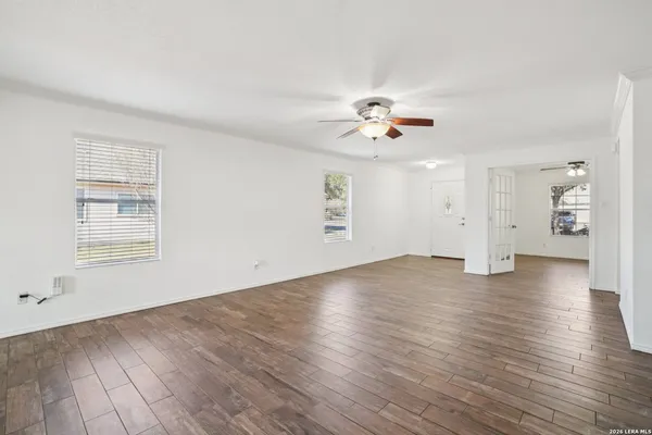 wooden floor in an empty room with a window