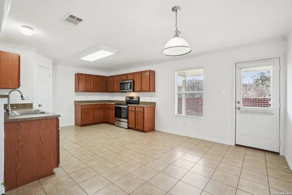 a large kitchen with cabinets and stainless steel appliances