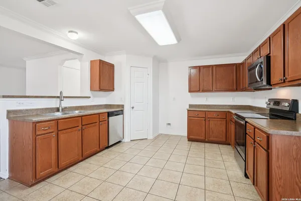 a kitchen with stainless steel appliances granite countertop a sink and cabinets