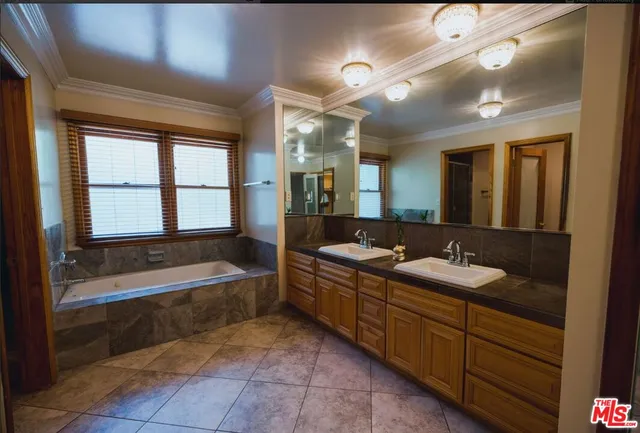 a spacious bathroom with a bathtub sink and mirror
