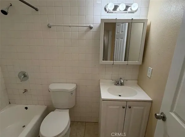 a bathroom with a toilet sink shower and mirror