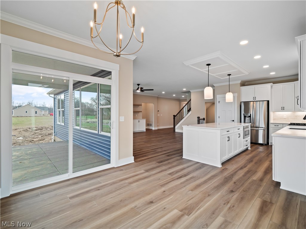 34270 Brookside Lane North Ridgeville, OH 44039 - Photo 50 of 50 Kitchen featuring open floor plan, a center island, suspended lighting, stainless steel appliances, and white cabinets