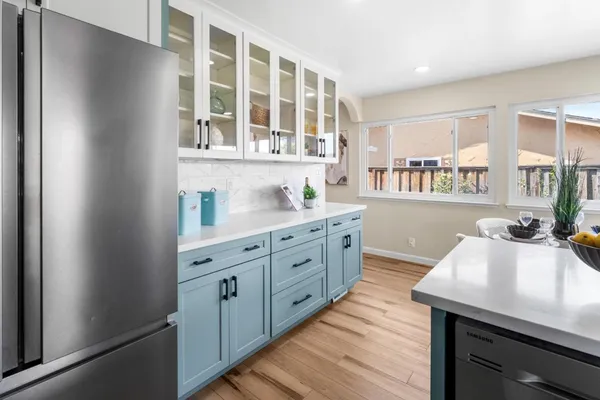 a kitchen with a sink cabinets and wooden floor
