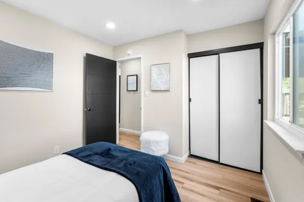 a bedroom with a bed and a window