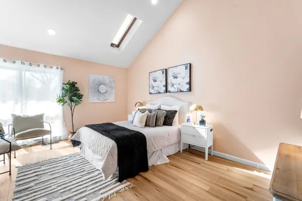 a bedroom with a bed and a potted plant