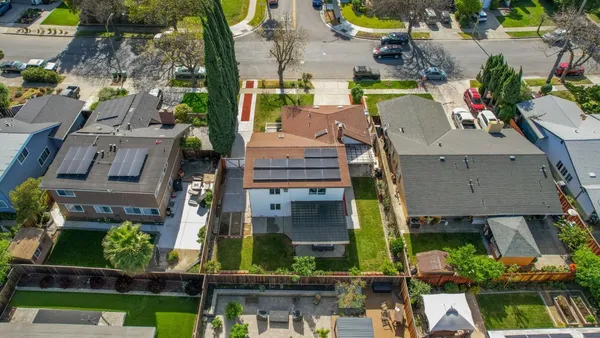 an aerial view of houses with outdoor space
