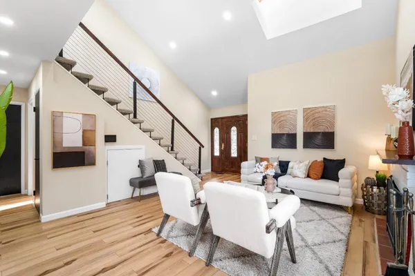 a living room with furniture and wooden floor