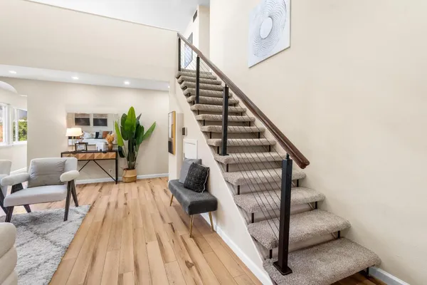 a view of entryway and hall with wooden floor