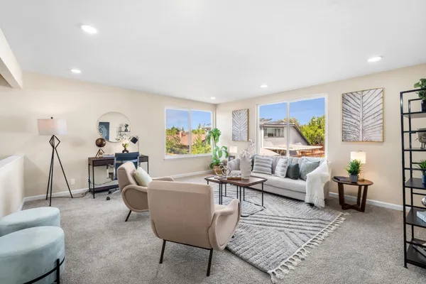 a living room with furniture and a large window