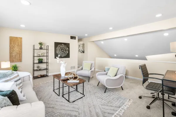 a living room with furniture and a rug