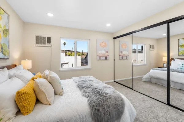 a bedroom with a bed and walk in closet