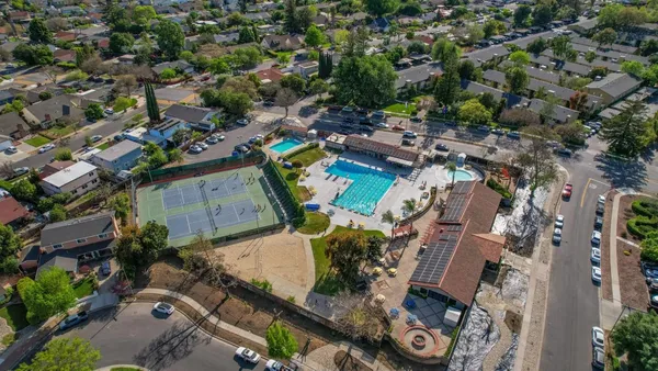 an aerial view of a residential houses with outdoor space