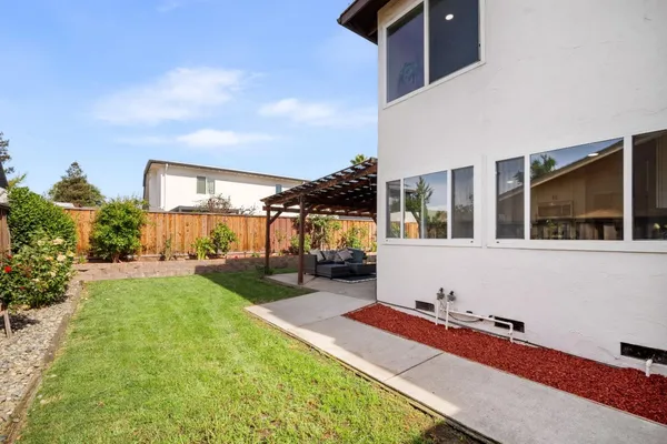 a house view with a sitting space and garden space