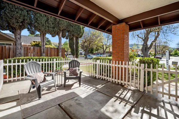 a view of a chairs and table in the patio