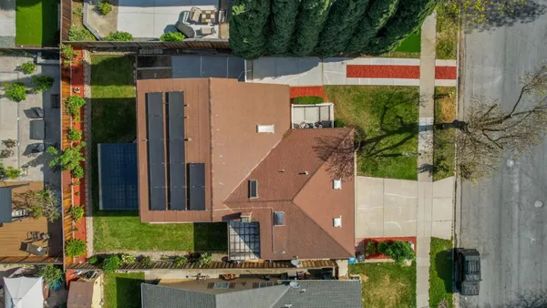 aerial view of a house with a yard
