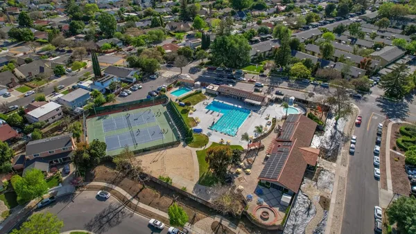 an aerial view of a residential houses with outdoor space