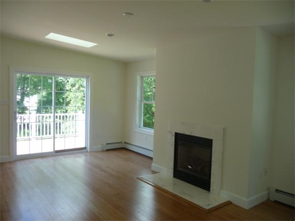 60 A Nashua Road Pepperell, MA 01463 - Photo 4 of 16 a view of an empty room with wooden floor and a window