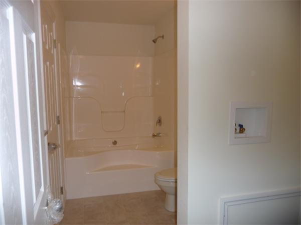 60 A Nashua Road Pepperell, MA 01463 - Photo 7 of 16 a bathroom with a bathtub and a shower