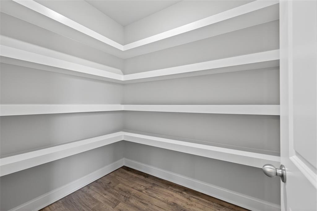 8845 Jot Em Down Road Gainesville, GA 30506 - Photo 28 of 87 a view of walk in closet with empty racks