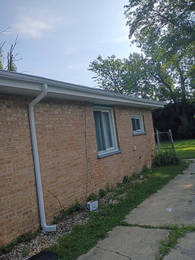 16029 Circle Drive Markham, IL 60428 - Photo 3 of 12 a front view of a house with garden