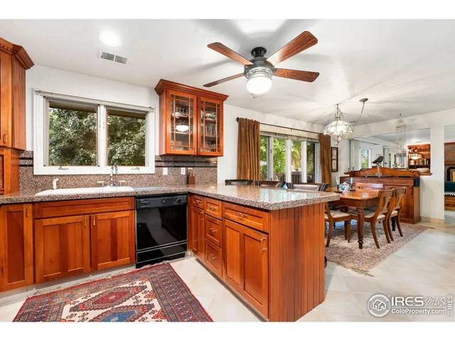 a dining room with furniture a chandelier and wooden floor